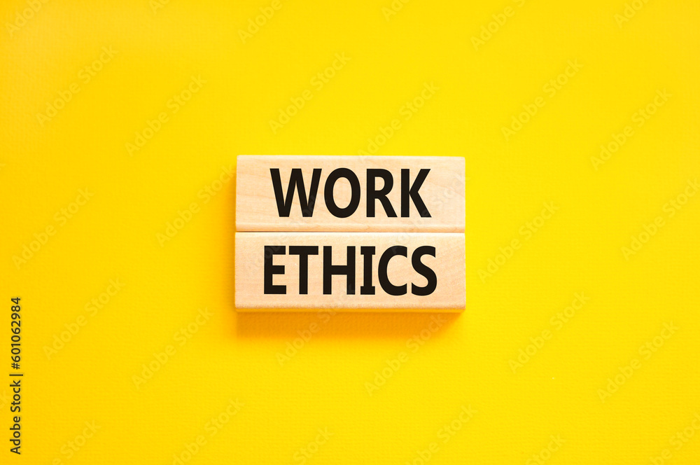 Work ethics symbol. Concept words Work ethics on beautiful wooden block. Beautiful yellow table yellow background. Business and Work ethics concept. Copy space. Work ethics symbol. Concept words Work ethics on beautiful wooden block. Beautiful yellow table yellow background. Business and Work ethics concept. Copy space.