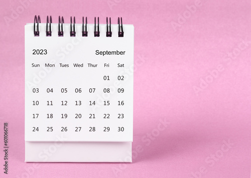 The September 2022 desk calendar on pink color background.