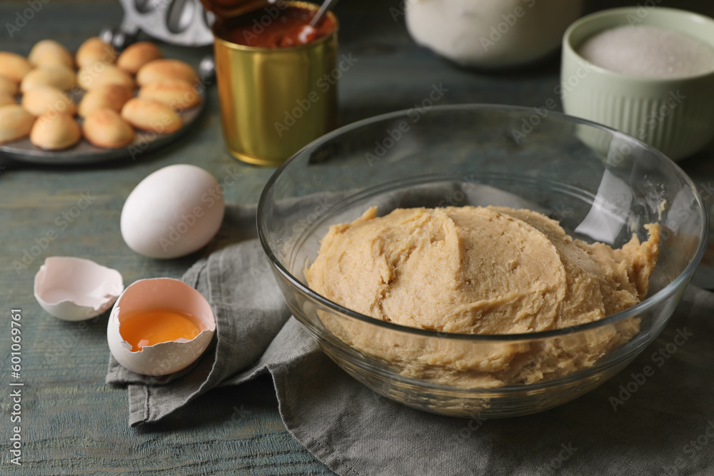 Dough for walnut shaped cookies and eggs on wooden table Dough for walnut shaped cookies and eggs on wooden table