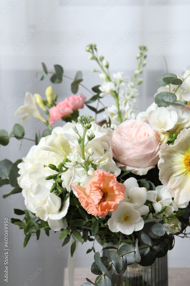 Bouquet of beautiful flowers on light background, closeup