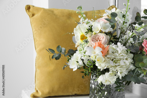 Bouquet of beautiful fresh flowers near pillow