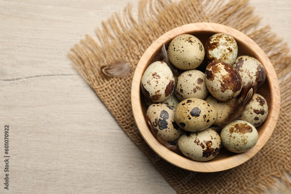 Speckled quail eggs on white wooden table, top view. Space for text Speckled quail eggs on white wooden table, top view. Space for text