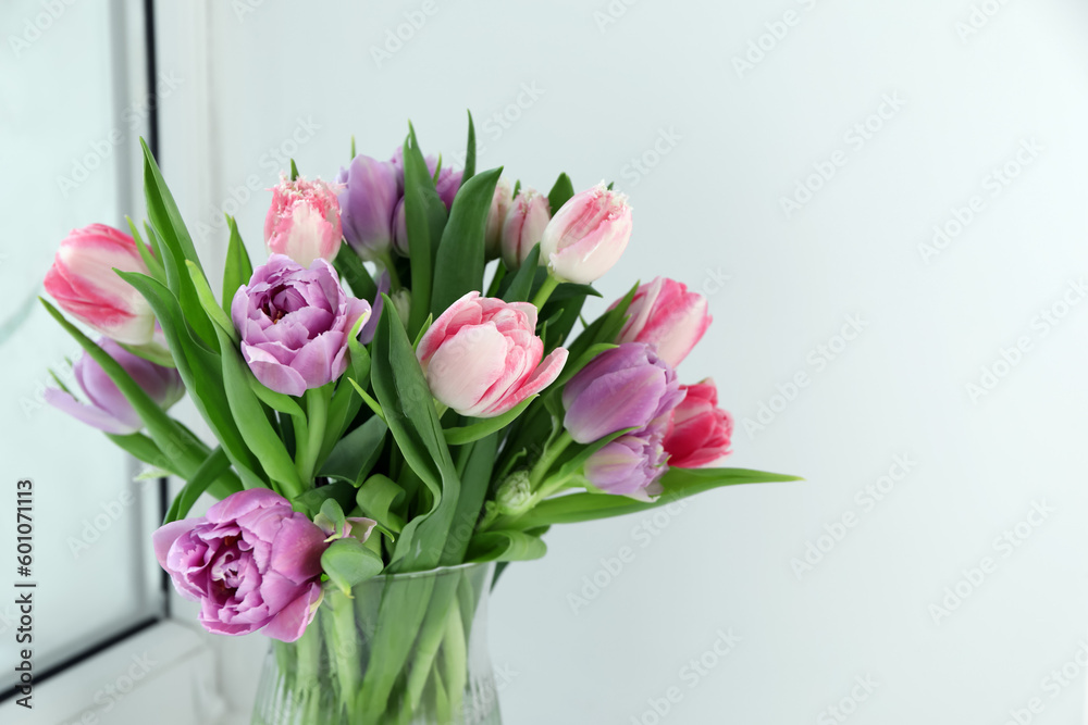Obraz premium Beautiful bouquet of colorful tulip flowers indoors. Space for text
