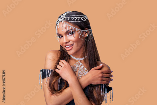 Fashion Portrait beautiful African American Woman with Perfect oriental make-up and white gold and diamond jewelry on head and neck model smiles and looks at the camera. isolated.  