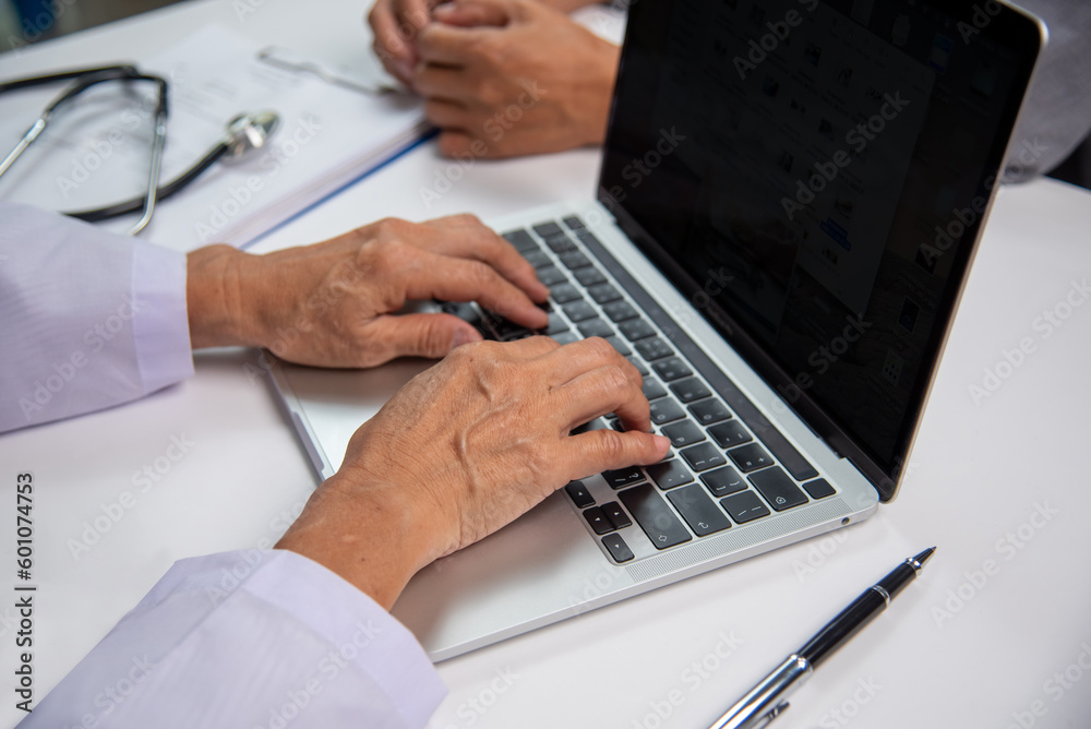 Female doctor using computer to look at patient report and history.medical apps, consulting online, Healthcare and medical concept. Female doctor using computer to look at patient report and history.medical apps, consulting online, Healthcare and medical concept.