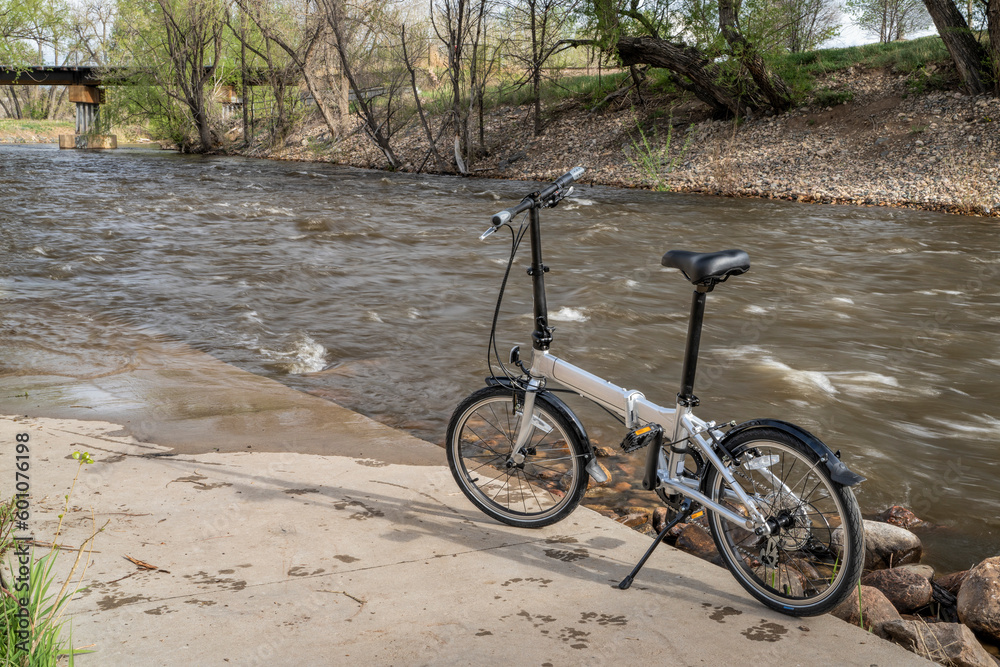 lightweight folding bike at whitewater park on the Poudre River in downtown of Fort Collins, Colorado, spring scenery lightweight folding bike at whitewater park on the Poudre River in downtown of Fort Collins, Colorado, spring scenery