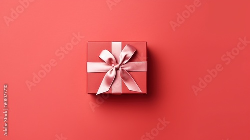 Gift box with  satin ribbon and bow on red background. Holiday gift with copy space. Birthday or Christmas present, flat lay, top view. Christmas giftbox concept. © mariof