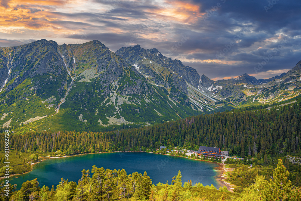 Fototapeta premium Picturesque panoramic view of Popradske Pleso, Tatra mountains, Slovakia. Lake Popradske pleso with mountain hotel in High Tatras.