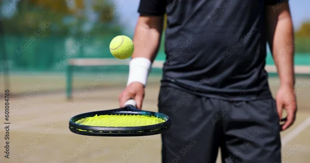 tennis player bounce the ball on racket at outdoor game court. slow motion