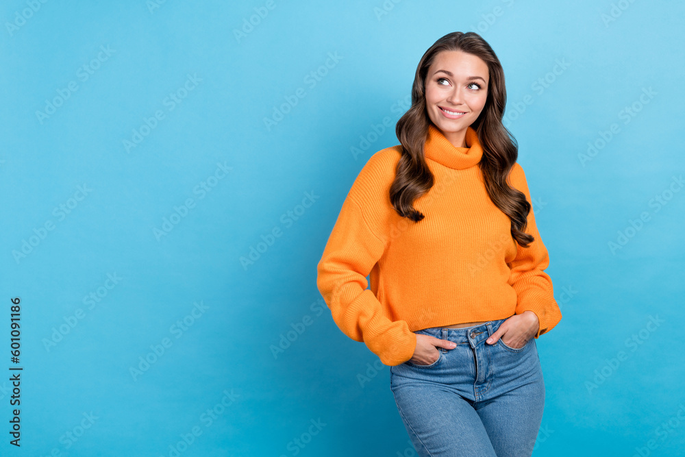 Photo of dreamy adorable woman wear orange sweater smiling looking emtpy space isolated blue color background Photo of dreamy adorable woman wear orange sweater smiling looking emtpy space isolated blue color background
