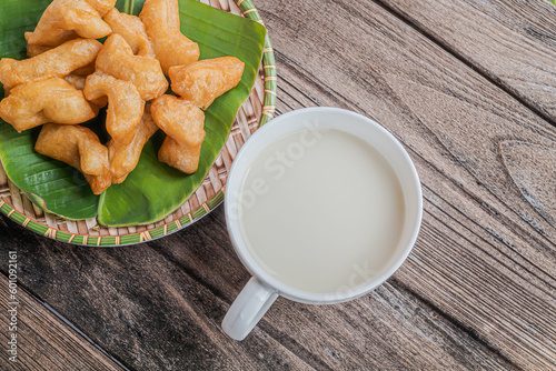 Cup of soybean milk with deep fried dough stick on the table healthy for breakfast.