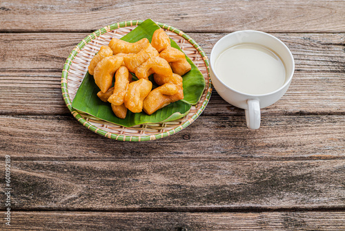 Cup of soybean milk with deep fried dough stick on the table healthy for breakfast.