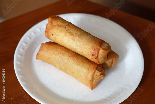 Lumpia or lunpia, traditional snacks from Indonesia. Traditional spring rolls contain stir-fried bamboo shoots, eggs, and chicken or shrimp photo