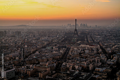 Aerial view of Paris at sunset with the Eiffel Tower and La Défense business district in the background, as seen from the Tour Montparnasse, France © Alexandre ROSA