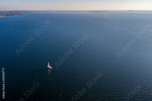 Masurian Lake District in Poland - lonely sailboat on a large lake - drone aerial landscape photography © Łukasz Tyczkowski