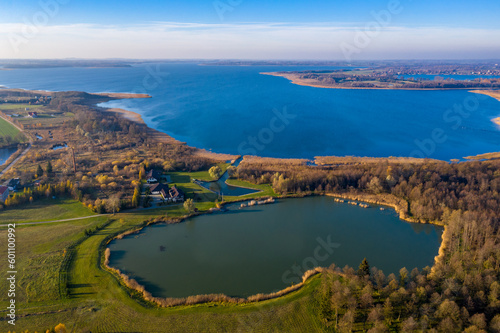 Masurian Lake District in Poland - beautifiul drone landscape, blue water, forest, autumn sunset time, Mazury great lakes