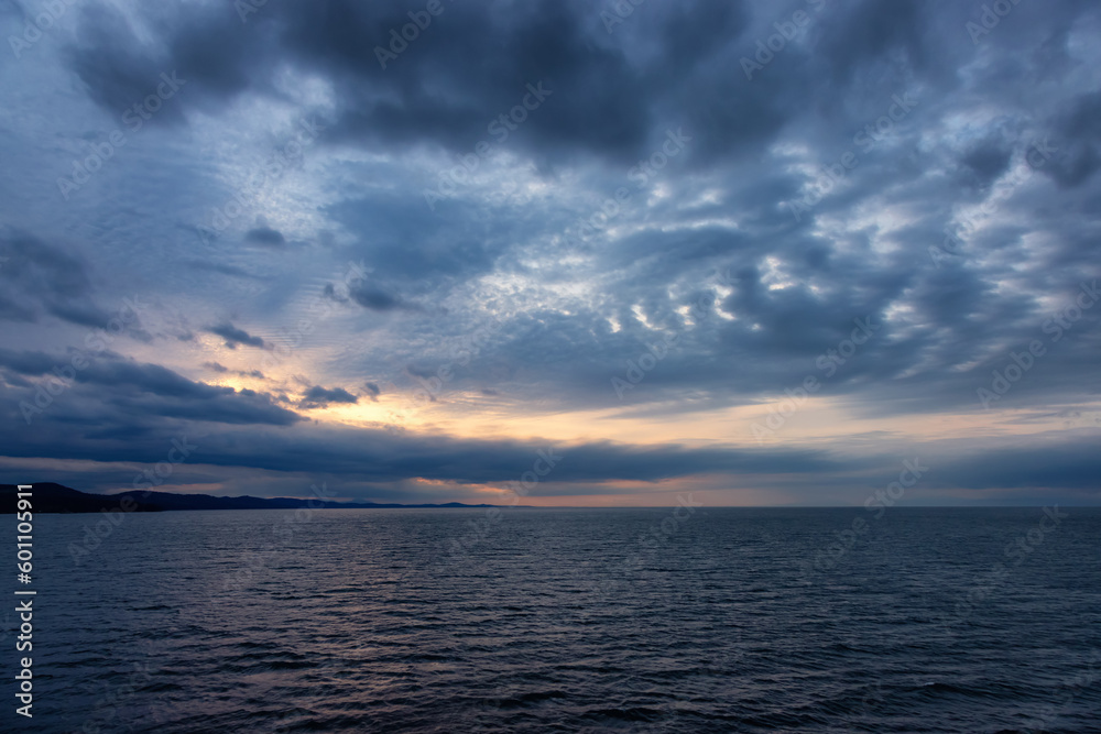 Cloudy Cloudscape during stormy everning on the West Coast of Pacific Ocean. British Columbia, Canada. Sunset Sky