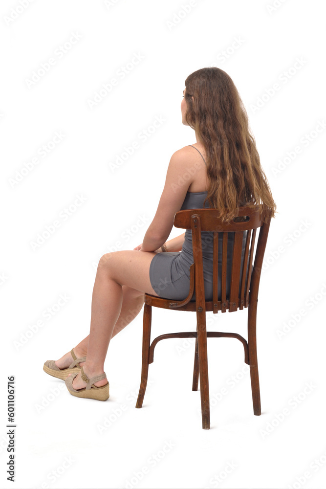 back side and view of a young girl sitting on chair on white background back side and view of a young girl sitting on chair on white background
