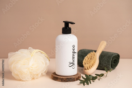 shampoo, sponge and towel on a light background.