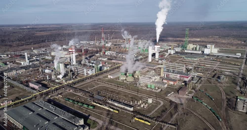 Chemistry Factory in Lithuania, Achema in Jonava City. Clear Blue Sky and Smoke Stacks in Background. Drone Chemistry Factory in Lithuania, Achema in Jonava City. Clear Blue Sky and Smoke Stacks in Background. Drone