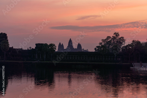 Angkor wat in Cambodia caught with a vibrant sunrise .