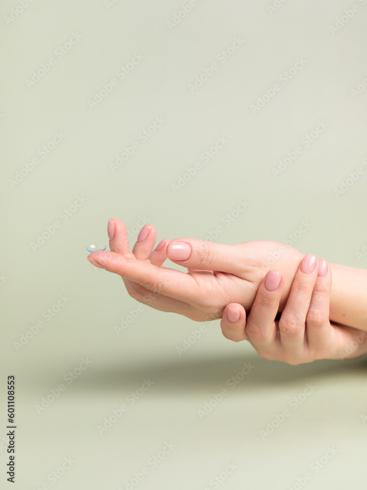 Eye lens, lens fluid, lens case. Woman hands. Eye lens, lens fluid, lens case. Woman hands.