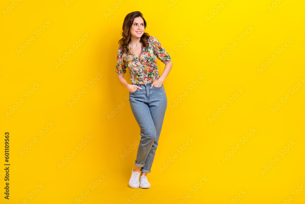 Full body photo cadre of dreaming funky girl wear spring flowers print posing look novelty shopping day isolated on yellow color background Full body photo cadre of dreaming funky girl wear spring flowers print posing look novelty shopping day isolated on yellow color background