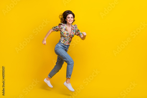 Full body size photo of running motivation young woman wear spring time outfit explore environment isolated on yellow color background © deagreez
