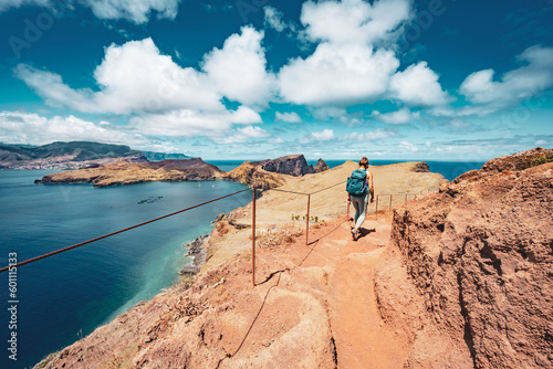 Athletic woman hikes along hike trail with scenic view on the beautiful Madeiran island. São Lourenço, Madeira Island, Portugal, Europe.