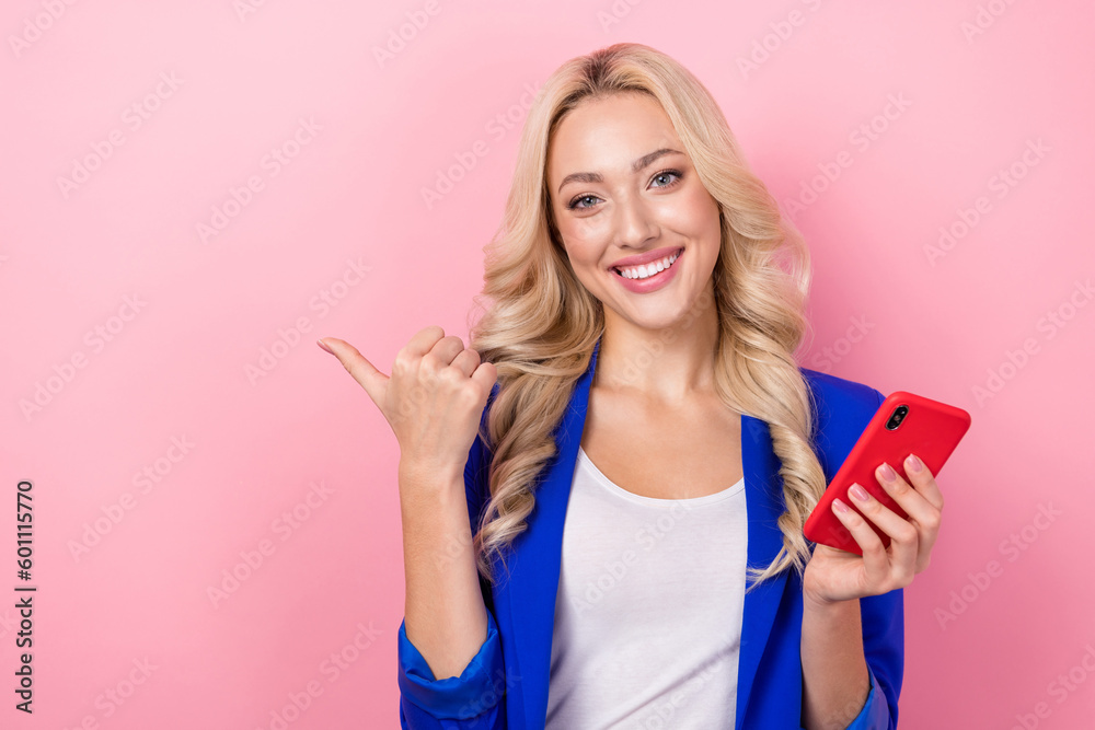 Photo of young funny business blogger girl wear blue blazer hold iphone direct finger empty space subscribe channel isolated on pink color background Photo of young funny business blogger girl wear blue blazer hold iphone direct finger empty space subscribe channel isolated on pink color background