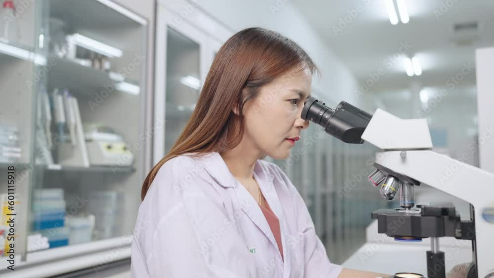 Woman biologist scientist Checking analyzes in lab microscope in modern medical laboratory Woman biologist scientist Checking analyzes in lab microscope in modern medical laboratory