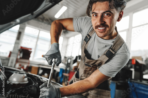 Mechanic examining car in auto car repair service center