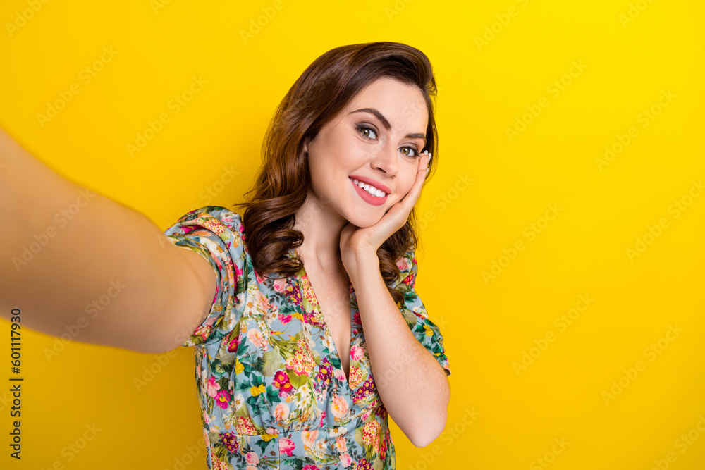 Photo of dreamy cute lady wear retro flower print blouse arm cheek recording video vlog isolated yellow color background Photo of dreamy cute lady wear retro flower print blouse arm cheek recording video vlog isolated yellow color background