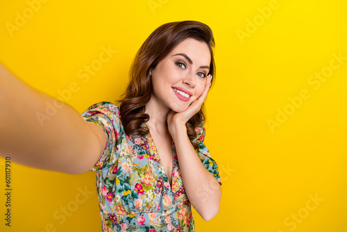 Photo of dreamy cute lady wear retro flower print blouse arm cheek recording video vlog isolated yellow color background