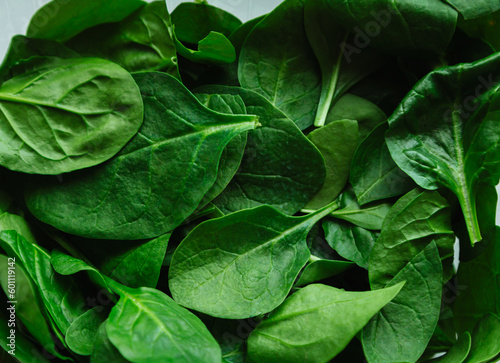 Spinach background full image. Top view, flat lay. Fresh green baby spinach leaves.