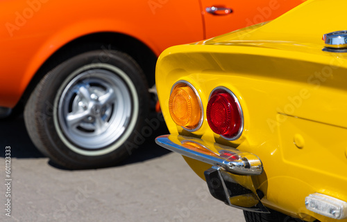 Close-up of the tale lights of yellow sport classic car. Beautifully restored details of a historic vehicle.