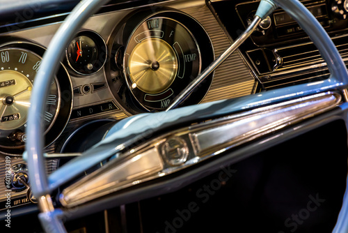 Classic american car dashboard. Steering wheel rim visible. Natural patina related to the age of the vehicle © Fotoforce
