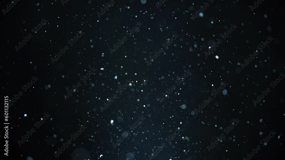 Real dust particles floating . Dust particles in the air. Light blue background