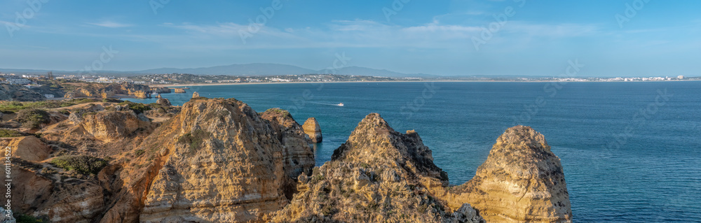 Fototapeta premium Ponta da Piedade (point of mercy) a headland with dramatic yellow-golden cliff-like rock formations, arches and grottos along the coastline of the town of Lagos, Algarve, Portugal
