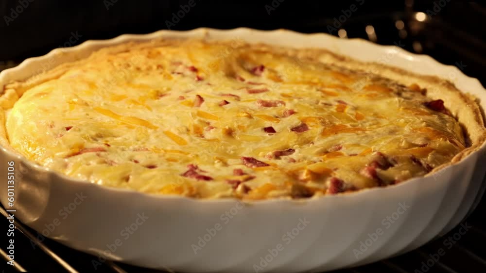 Homemade quiche pie with meat and cheese. French tart baking. Timelapse. Open pie with cheese baking in oven. Quiche lorraine. Close-up in 4K, UHD Homemade quiche pie with meat and cheese. French tart baking. Timelapse. Open pie with cheese baking in oven. Quiche lorraine. Close-up in 4K, UHD