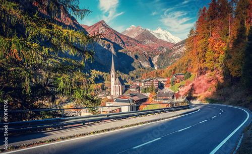 Amazing sunny morning scenery in European Alps. Wonderful nature view on mountain valley and popular place of Heiligenblut with St Vincent Church with the majestic Grossglockner mount on background photo