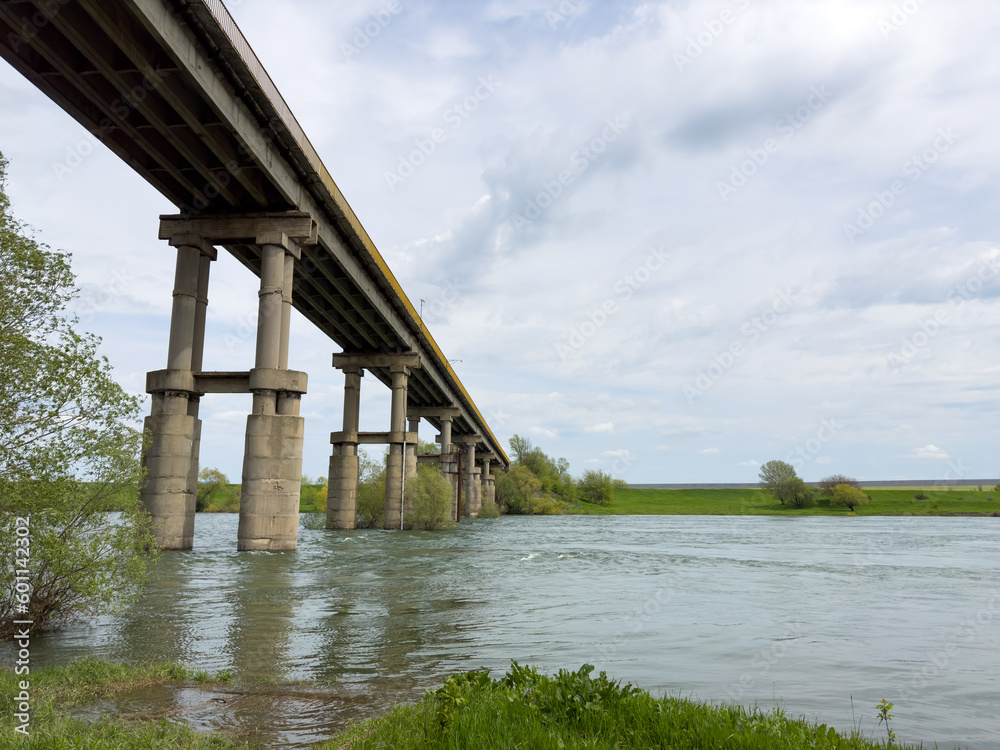 A long bridge over the river connects the two banks A long bridge over the river connects the two banks