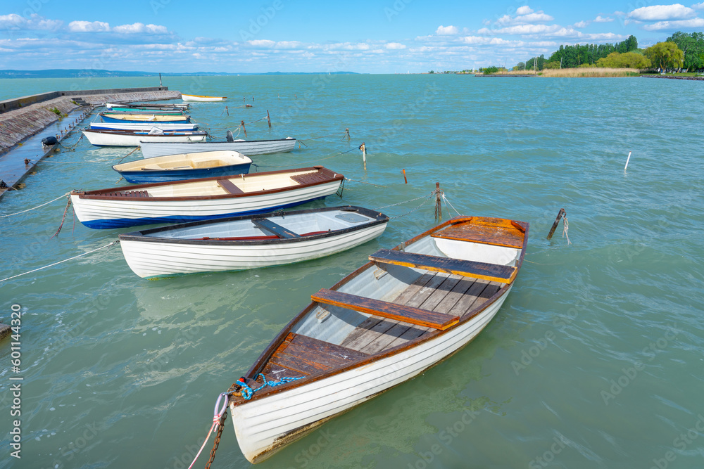 pier in Balatonlelle with colorful boats on lake Balaton blue sky and water