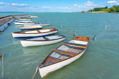 pier in Balatonlelle with colorful boats on lake Balaton blue sky and water © Bernadett