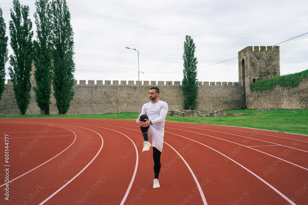 Fototapeta premium Man Warming Up Before Workout and Running