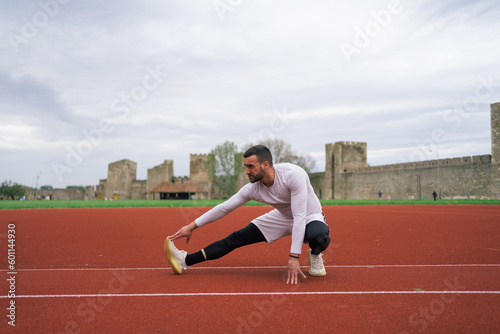 Man Warming Up and Stretching Before Workout and Running