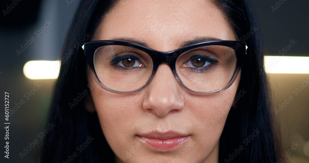 Front view of lovely positive successful dark-haired adult woman which wearing stylish glasses and looking at camera with confident face Front view of lovely positive successful dark-haired adult woman which wearing stylish glasses and looking at camera with confident face