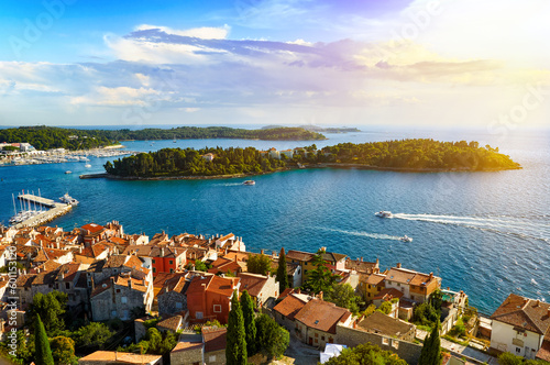 Rovinj city skyline overlooking the orange rooftops of old houses, the picturesque harbor and islands