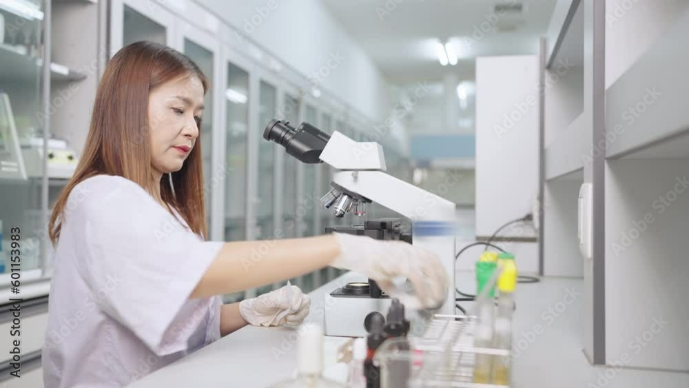 Woman biologist scientist Checking analyzes in lab microscope in modern medical laboratory Woman biologist scientist Checking analyzes in lab microscope in modern medical laboratory
