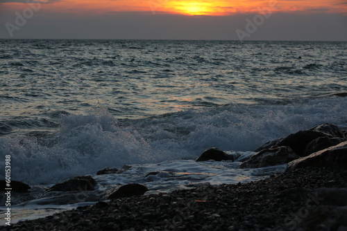 Sunset on the beach with a surf wave
